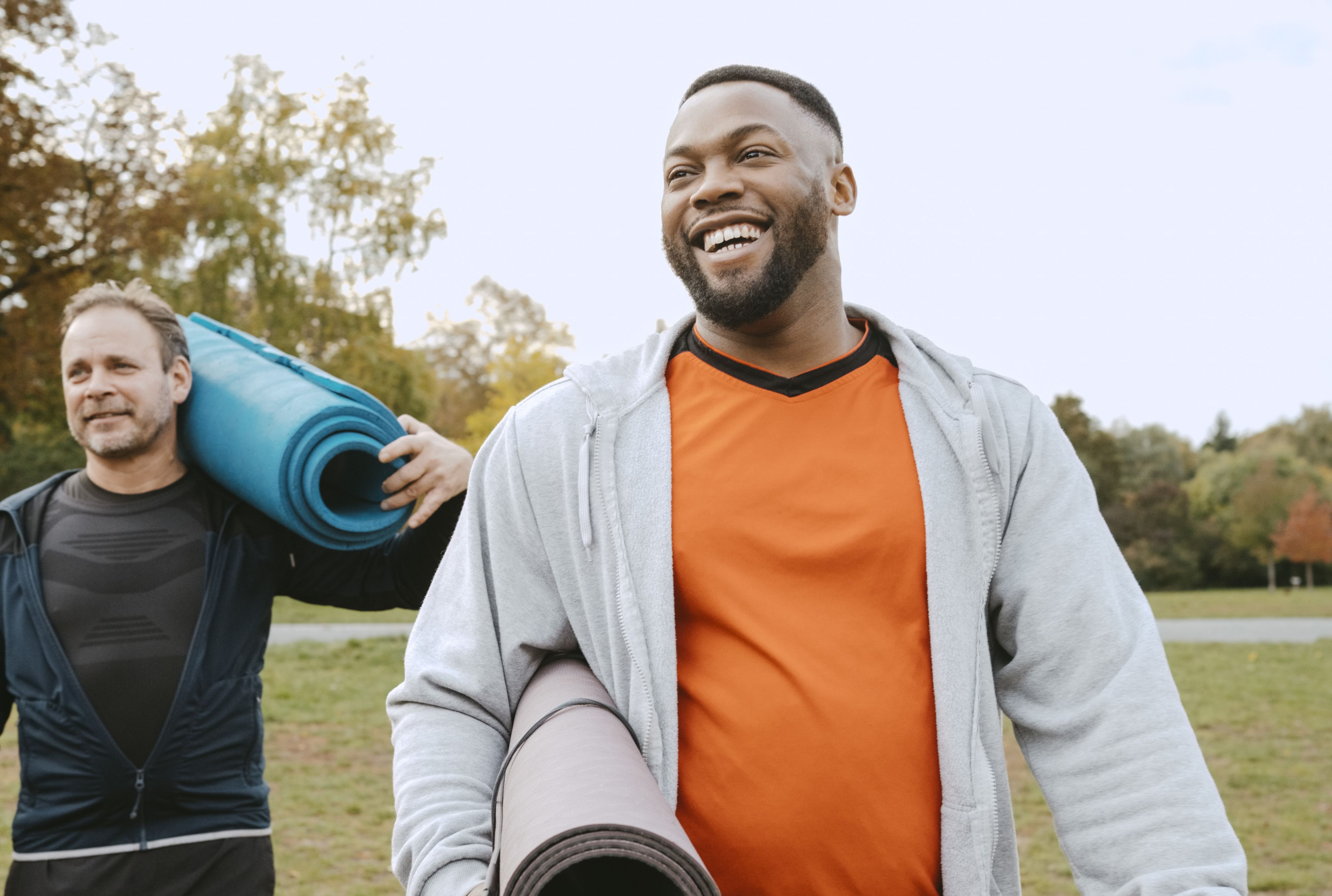 An image of two men walking to yoga class to improve their health.