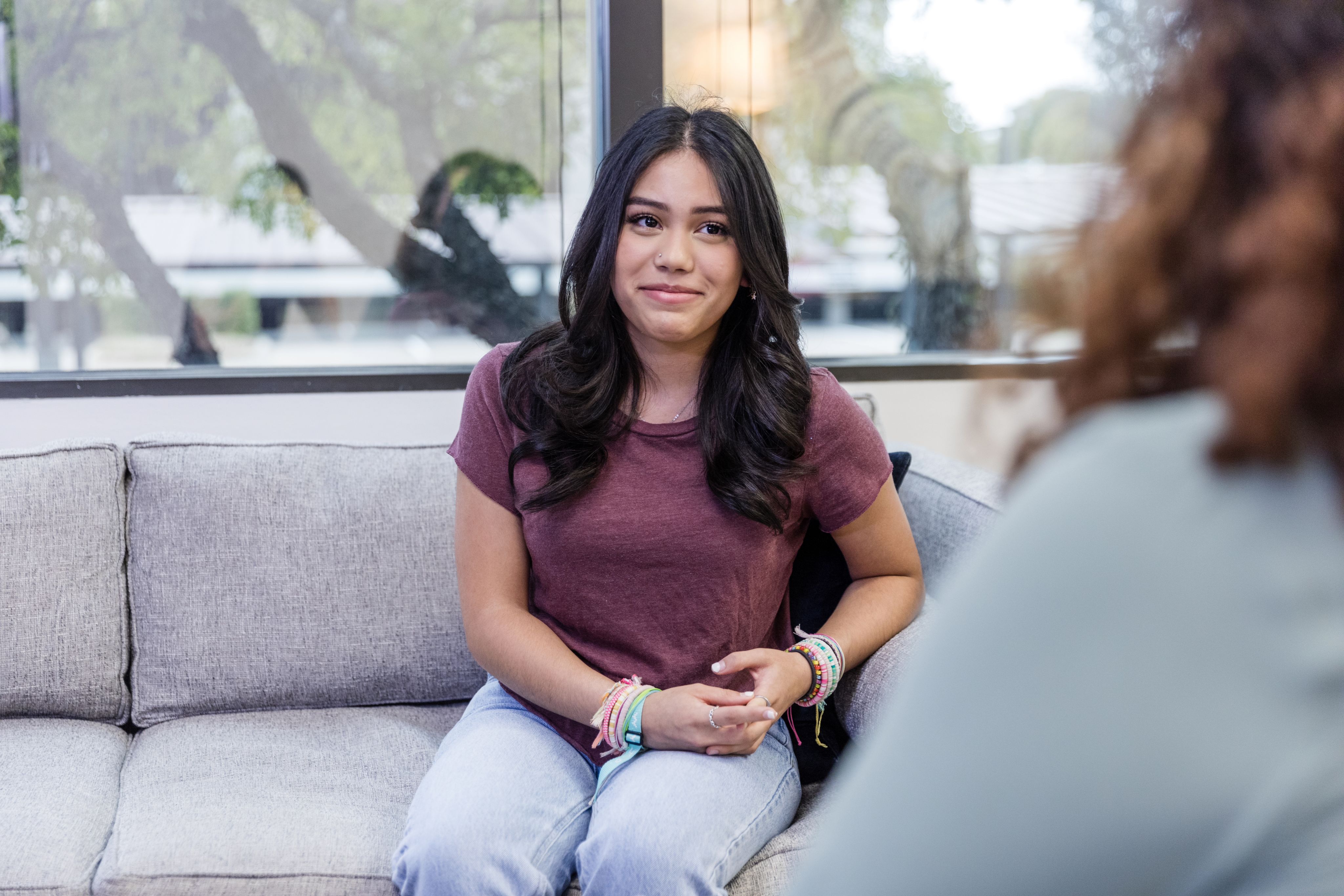 A photo of a college age girl talking with her doctor.